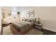 Comfortable bedroom with built-in cabinets, modern art, and a relaxing seating area by the window at 6537 Everett St, Arvada, CO 80004