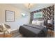 Charming bedroom with floral wallpaper, chandelier, and modern decor for a relaxing retreat at 6537 Everett St, Arvada, CO 80004