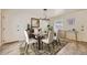 Bright dining room with modern chandelier, table setting, and neutral decor at 6537 Everett St, Arvada, CO 80004