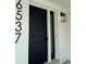 Modern black front door with sidelight and house number at 6537 Everett St, Arvada, CO 80004