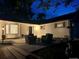 Exterior home view at twilight with front patio seating and manicured landscaping at 6537 Everett St, Arvada, CO 80004