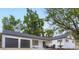 Charming exterior with white brick, modern dark trim, 2 car garage and inviting front patio at 6537 Everett St, Arvada, CO 80004