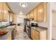 Functional kitchen featuring wood cabinets, stainless steel appliances and tile floor at 6537 Everett St, Arvada, CO 80004