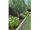 The landscaped backyard showcases a beautiful garden featuring trees, shrubs, and flowers at 6537 Everett St, Arvada, CO 80004