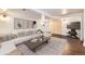 Inviting living room with comfortable seating, modern decor, and a stylish sliding barn door at 6537 Everett St, Arvada, CO 80004