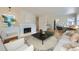 Bright living room with fireplace, modern furnishings and hardwood floors at 6537 Everett St, Arvada, CO 80004