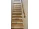 Clean and bright staircase showcasing natural wood steps and a matching handrail at 6537 Everett St, Arvada, CO 80004