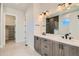 Modern bathroom featuring double vanity, quartz countertops, and herringbone-patterned tiled shower at 2750 E 102Nd Pl, Thornton, CO 80229