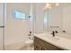 Bright bathroom with white subway tile, tub, toilet, and single sink vanity at 2750 E 102Nd Pl, Thornton, CO 80229