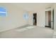 Light-filled bedroom with neutral carpet, a view to an ensuite, and two windows providing plenty of natural light at 2750 E 102Nd Pl, Thornton, CO 80229