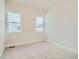 Carpeted bedroom with large windows offering great natural light at 2750 E 102Nd Pl, Thornton, CO 80229