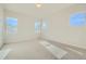 Bright, airy bedroom with neutral carpeting, three windows, and plenty of natural light at 2750 E 102Nd Pl, Thornton, CO 80229