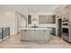Spacious open kitchen with a large center island, stainless steel appliances, ample counter space, and modern finishes at 2750 E 102Nd Pl, Thornton, CO 80229