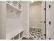 Mudroom with built-in bench and shelving with decorative tile flooring at 2750 E 102Nd Pl, Thornton, CO 80229