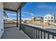 Enjoy neighborhood views from this inviting porch with dark-stained wood railings and ample space for outdoor seating at 2750 E 102Nd Pl, Thornton, CO 80229
