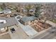 Aerial view of a single-story house with a long driveway and a detached garage with solar panels at 11360 Irma Dr, Northglenn, CO 80233