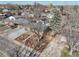 Aerial view of a single-story house showcasing landscaping, a long driveway, and the surrounding neighborhood at 11360 Irma Dr, Northglenn, CO 80233