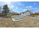 Large backyard features a sunken trampoline and partially fenced yard at 11360 Irma Dr, Northglenn, CO 80233
