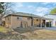 Backyard view of a single-story house with a covered patio at 11360 Irma Dr, Northglenn, CO 80233