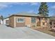 Well-maintained single-story home with a large driveway and detached garage at 11360 Irma Dr, Northglenn, CO 80233