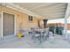 Covered patio area with outdoor dining setup, perfect for enjoying outdoor meals and gatherings at 11360 Irma Dr, Northglenn, CO 80233