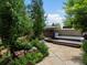 Serene backyard featuring lush landscaping, stone patio, and a relaxing hot tub at 405 S University Blvd, Denver, CO 80209