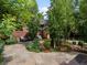 Picturesque backyard with beautiful landscaping, stone patio, and outdoor seating area at 405 S University Blvd, Denver, CO 80209