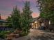 Serene backyard oasis featuring a stone patio, lush landscaping, water feature, and a cozy seating area for relaxation at 405 S University Blvd, Denver, CO 80209