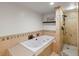 Bathroom features a soaking tub with a shower, and beige tiling at 405 S University Blvd, Denver, CO 80209