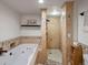 Bathroom featuring a soaking tub, separate shower, and custom tiled walls at 405 S University Blvd, Denver, CO 80209