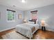 Bright bedroom with hardwood floors and two windows at 405 S University Blvd, Denver, CO 80209