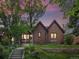 Charming brick home with manicured lawn and mature trees, showcasing a well-maintained facade and inviting entrance at 405 S University Blvd, Denver, CO 80209