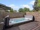 Inviting hot tub with wood decking and privacy walls, perfect for relaxation at 405 S University Blvd, Denver, CO 80209