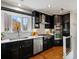 Modern kitchen has stainless steel appliances and black cabinets at 405 S University Blvd, Denver, CO 80209