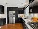 Kitchen offers stainless steel refrigerator, gas range, and dark wood cabinetry at 405 S University Blvd, Denver, CO 80209