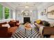Bright living room features a fireplace, checkered rug, and modern seating at 405 S University Blvd, Denver, CO 80209