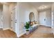 Light and airy entryway with bench, mirror, and wood floors at 4306 Canyata Dr, Elizabeth, CO 80107