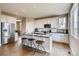 Modern kitchen with white cabinets, island, and stainless steel appliances at 4306 Canyata Dr, Elizabeth, CO 80107