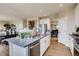 Open kitchen with island, stainless steel appliances, and white cabinets at 4306 Canyata Dr, Elizabeth, CO 80107