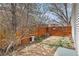 Landscaped backyard with a bird bath, garden bed, and a charming wood fence with gate at 12418 Albion St, Thornton, CO 80241