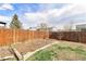 Spacious backyard with a garden area and wood fence, perfect for outdoor activities at 12418 Albion St, Thornton, CO 80241