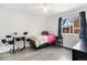 This bedroom features a twin bed, electronic drum set, a window, and laminate flooring at 12418 Albion St, Thornton, CO 80241