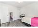 Bright bedroom features a laminate floor, closet, and twin bed with pink accents at 12418 Albion St, Thornton, CO 80241