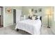 This bedroom features a bed with a white comforter, carpet, a closet, and artwork at 12418 Albion St, Thornton, CO 80241