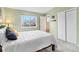 This bedroom features a bed with a white comforter, carpet, and a bright window at 12418 Albion St, Thornton, CO 80241