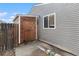 Exterior view of the home featuring a storage shed and window, with durable siding at 12418 Albion St, Thornton, CO 80241