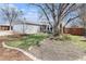 A lovely single-Gathering home features a big tree and manicured landscaping at 12418 Albion St, Thornton, CO 80241