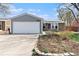 Charming single-Gathering home features a two-car garage, brick, and gray siding exterior at 12418 Albion St, Thornton, CO 80241