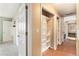 Hallway featuring wood floors and carpet, closet, doors and neutral paint at 12418 Albion St, Thornton, CO 80241