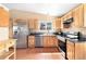 Bright kitchen with wooden cabinets, stainless steel appliances, and ample counter space at 12418 Albion St, Thornton, CO 80241